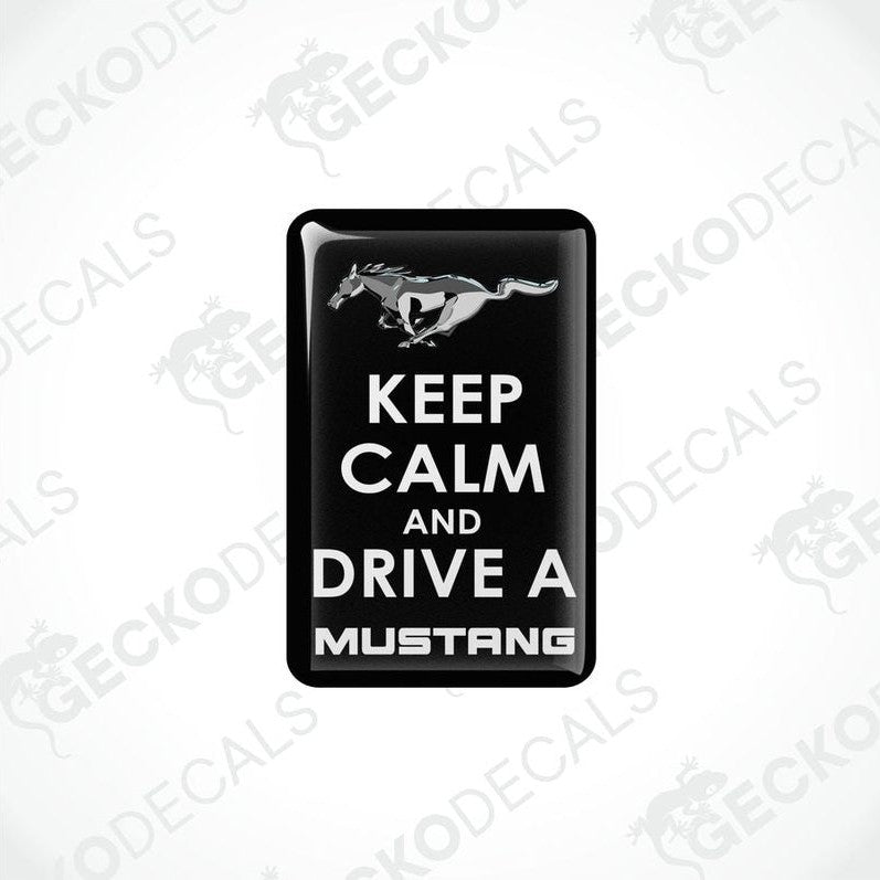 Rectangular black vehicle decals with white text and graphics, one depicting a pony and the other the phrase 'KEEP CALM AND DRIVE A MUSTANG'.