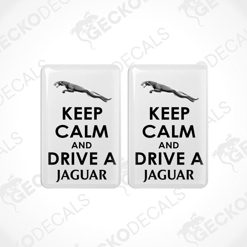 Two white vinyl stickers with 'KEEP CALM AND DRIVE A JAGUAR' text and a Jaguar logo.