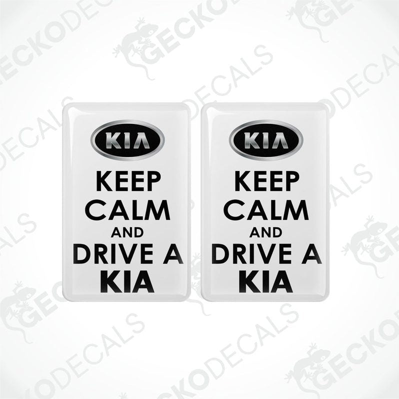 Two white vinyl decals with black text that read 'KEEP CALM AND DRIVE A KIA'.