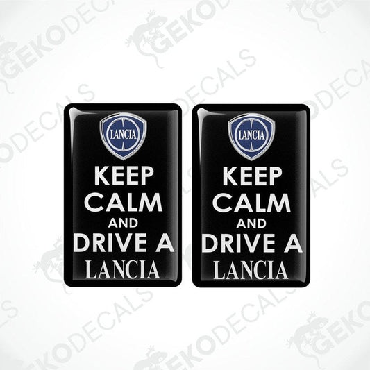 Two black vinyl decals with white text saying 'KEEP CALM AND DRIVE A LANCIA' and the Lancia logo above the text.