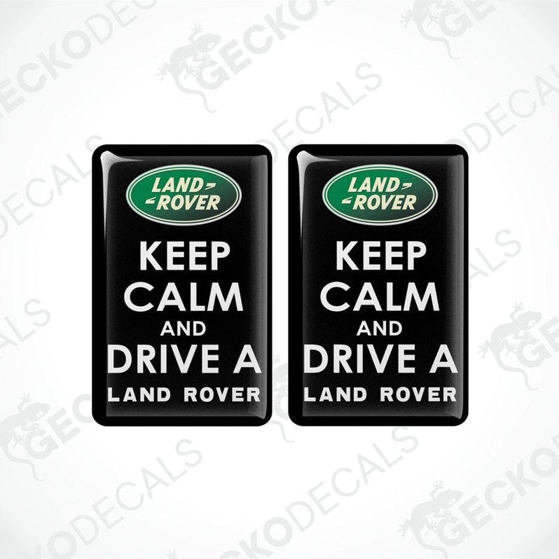 Two black vinyl stickers with the text 'KEEP CALM AND DRIVE A LAND ROVER' and the Land Rover logo.