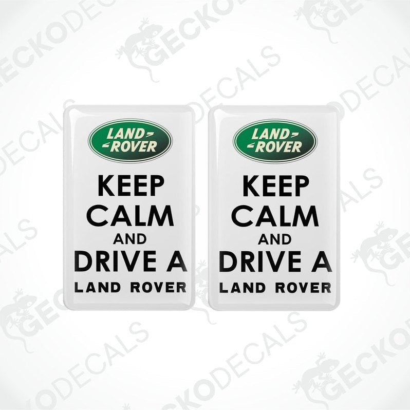 Two white vinyl stickers with the text 'KEEP CALM AND DRIVE A LAND ROVER' and the Land Rover logo.