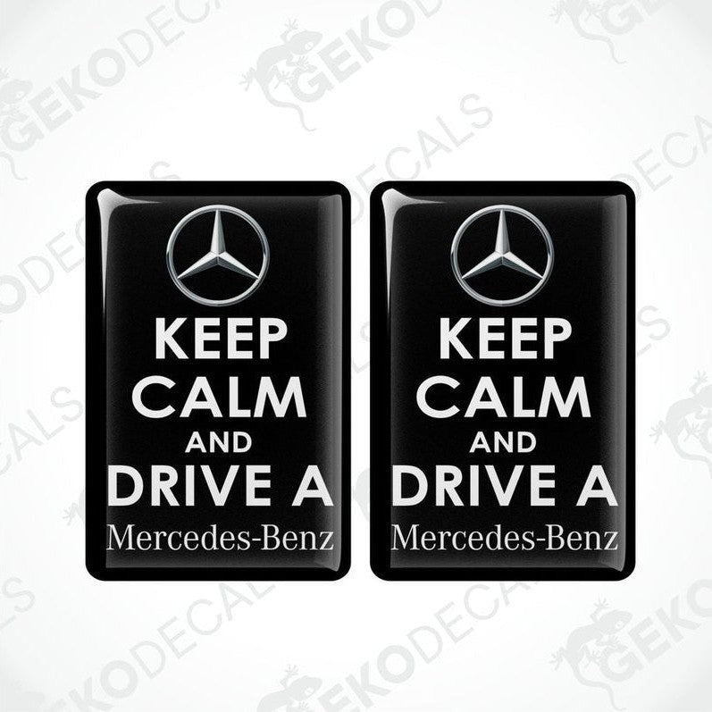 Two rectangular black vinyl decals with white text and the Mercedes-Benz logo, one decal reads 'KEEP CALM AND DRIVE A' and the other reads 'Mercedes-Benz'.