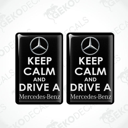 Two rectangular black vinyl decals with white text and the Mercedes-Benz logo, one decal reads 'KEEP CALM AND DRIVE A' and the other reads 'Mercedes-Benz'.