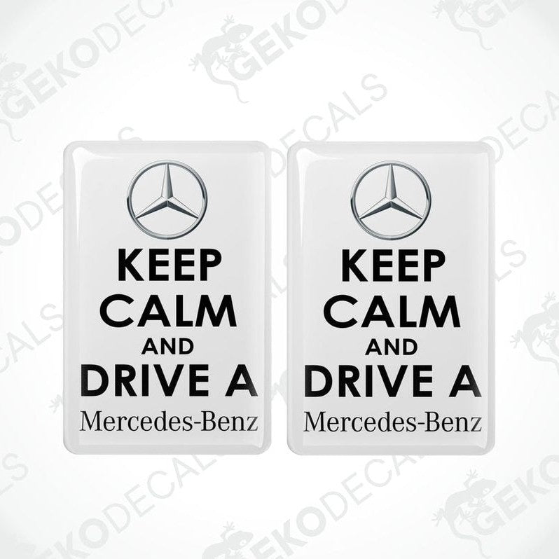 Two rectangular white vinyl decals with white text and the Mercedes-Benz logo, one decal reads 'KEEP CALM AND DRIVE A' and the other reads 'Mercedes-Benz'.