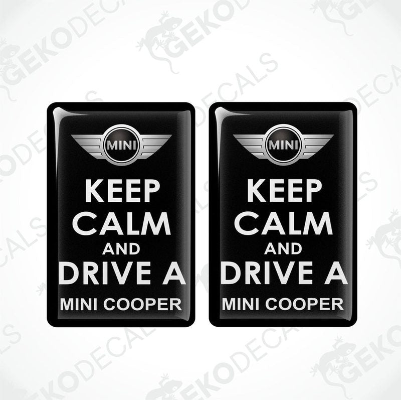 Two black vinyl stickers with the text 'KEEP CALM AND DRIVE A MINI COOPER' and the MINI COOPER logo in the center.