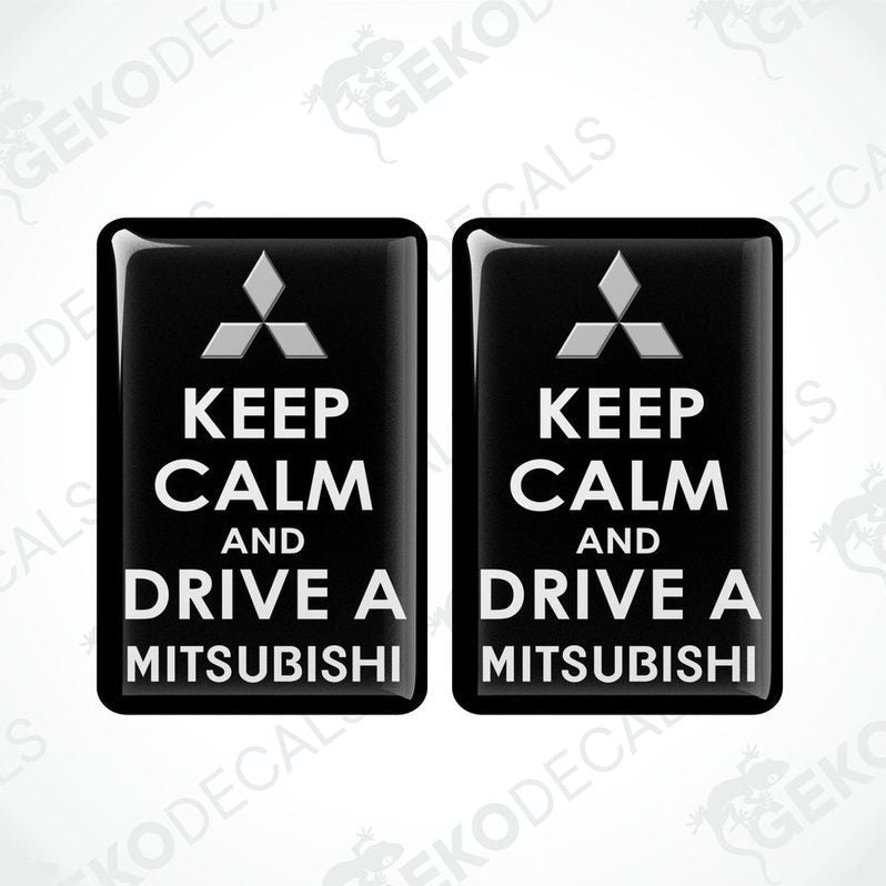 Two black vinyl stickers with the text 'KEEP CALM AND DRIVE A MITSUBISHI' and a white triangle logo on each sticker.