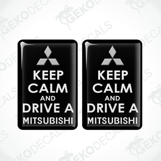 Two black vinyl stickers with the text 'KEEP CALM AND DRIVE A MITSUBISHI' and a white triangle logo on each sticker.
