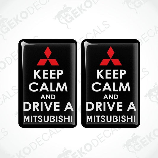 Two black vinyl stickers with the text 'KEEP CALM AND DRIVE A MITSUBISHI' and a white triangle logo on each sticker.