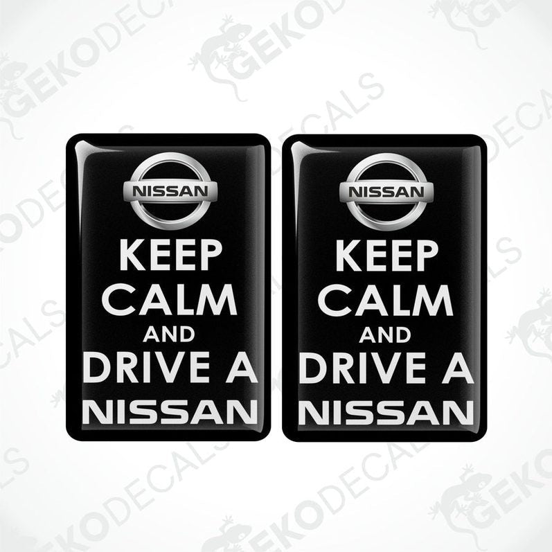 Two black vinyl stickers with the text 'KEEP CALM AND DRIVE A NISSAN' and the NISSAN logo.