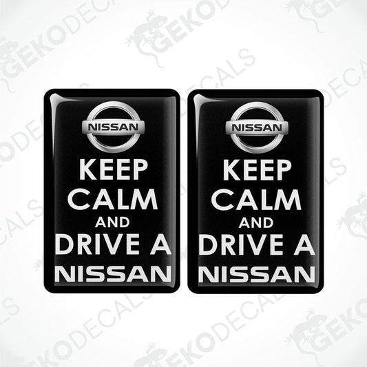 Two black vinyl stickers with the text 'KEEP CALM AND DRIVE A NISSAN' and the NISSAN logo.