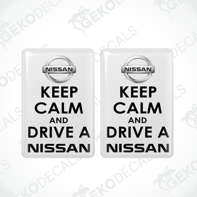 Two white vinyl stickers with the text 'KEEP CALM AND DRIVE A NISSAN' and the NISSAN logo.
