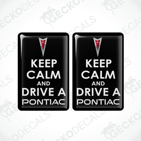 Two rectangular black vinyl decals with the text 'KEEP CALM AND DRIVE A PONTIAC' and the Pontiac logo in red and white.