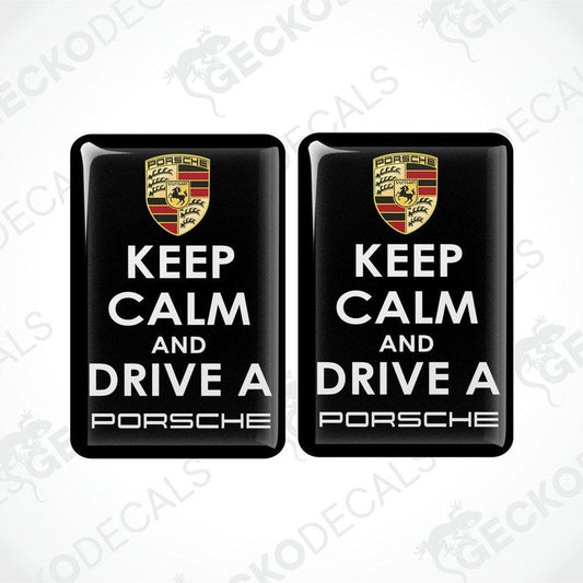 Two black vinyl decals with the text 'KEEP CALM AND DRIVE A PORSCHE' and the Porsche logo in white and yellow