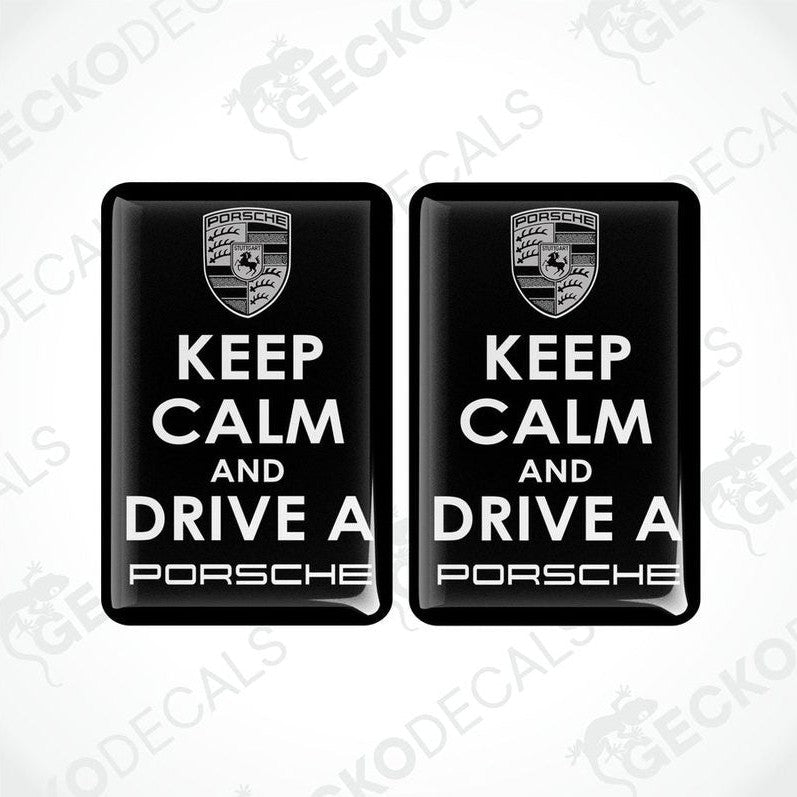 Two black vinyl stickers with the text 'KEEP CALM AND DRIVE A PORSCHE' and the Porsche logo.