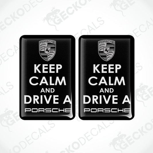 Two black vinyl stickers with the text 'KEEP CALM AND DRIVE A PORSCHE' and the Porsche logo.