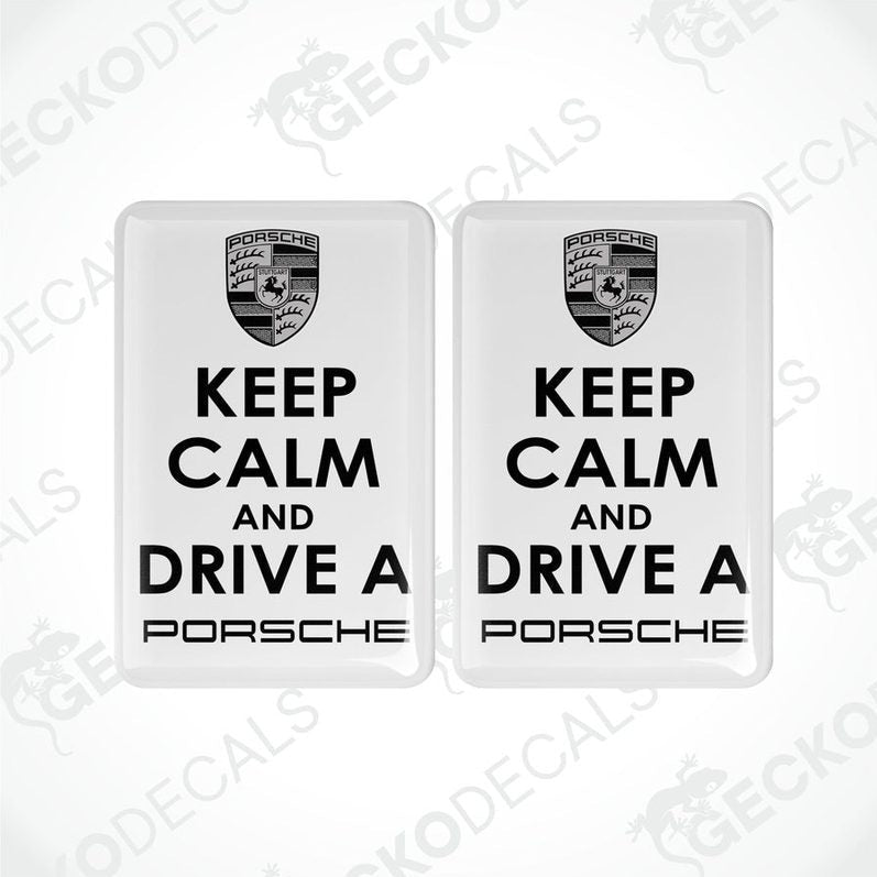 Two withe vinyl stickers with the text 'KEEP CALM AND DRIVE A PORSCHE' and the Porsche logo.