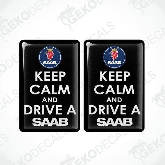 Two rectangular black vinyl decals with white text and the Saab car logo at the top, one decal saying 'KEEP CALM AND DRIVE A SAAB' and the other with a mirror image of the text and logo.