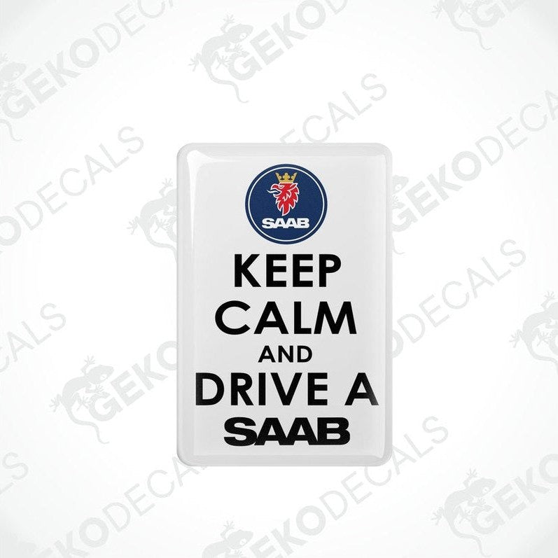 Rectangular withe vinyl decals with black text and the Saab car logo at the top, one decal saying 'KEEP CALM AND DRIVE A SAAB' and the other with a mirror image of the text and logo.