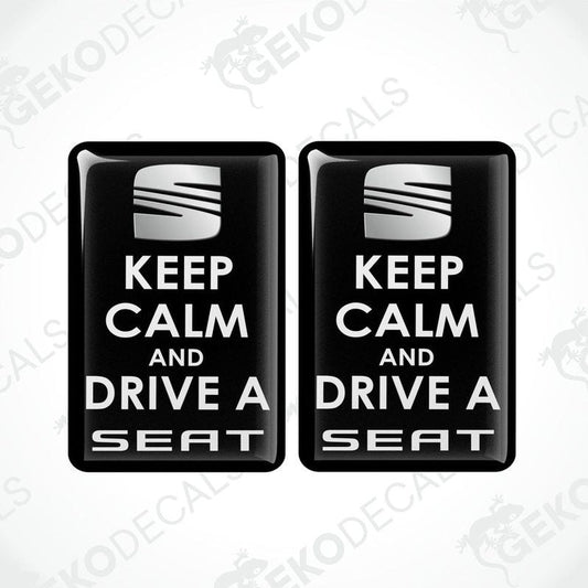 Two rectangular black vehicle decals with white text saying 'KEEP CALM AND DRIVE A SEAT'