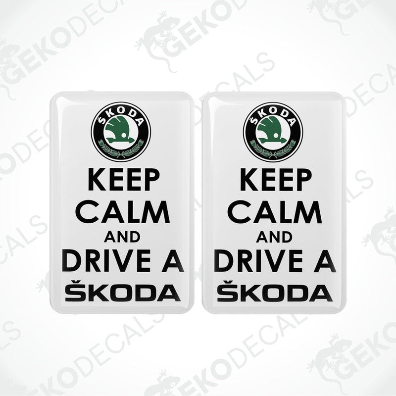 Two withe vinyl stickers with the text 'KEEP CALM AND DRIVE A SKODA' and the Skoda logo.