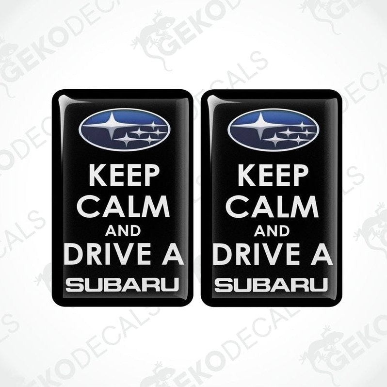 Two black vinyl stickers with the text 'KEEP CALM AND DRIVE A SUBARU' and the Subaru logo above the text.