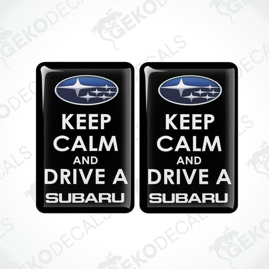 Two black vinyl stickers with the text 'KEEP CALM AND DRIVE A SUBARU' and the Subaru logo above the text.