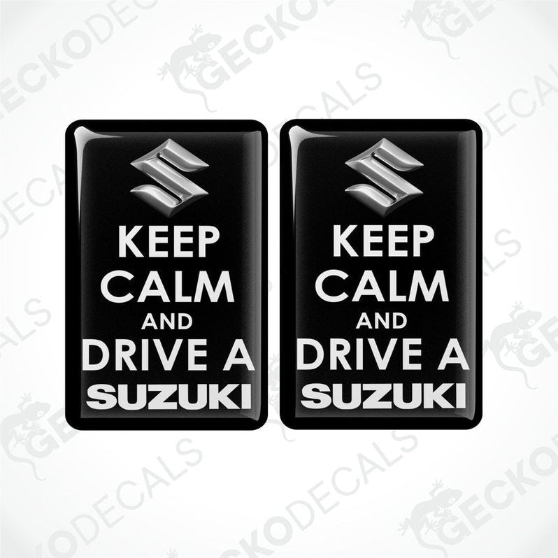 Two black vinyl stickers with the text 'KEEP CALM AND DRIVE A SUZUKI' and the Suzuki logo.