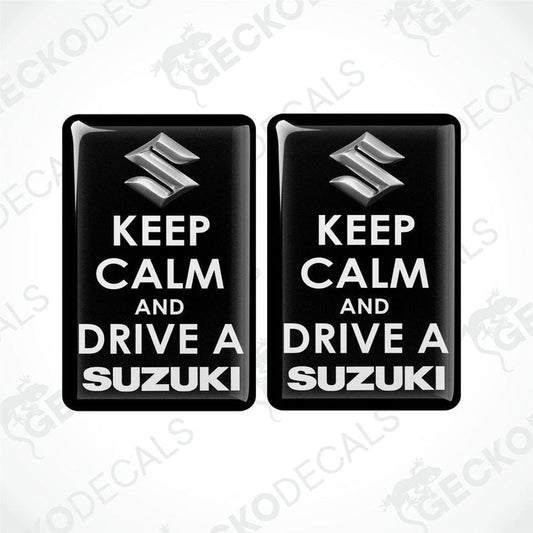 Two black vinyl stickers with the text 'KEEP CALM AND DRIVE A SUZUKI' and the Suzuki logo.