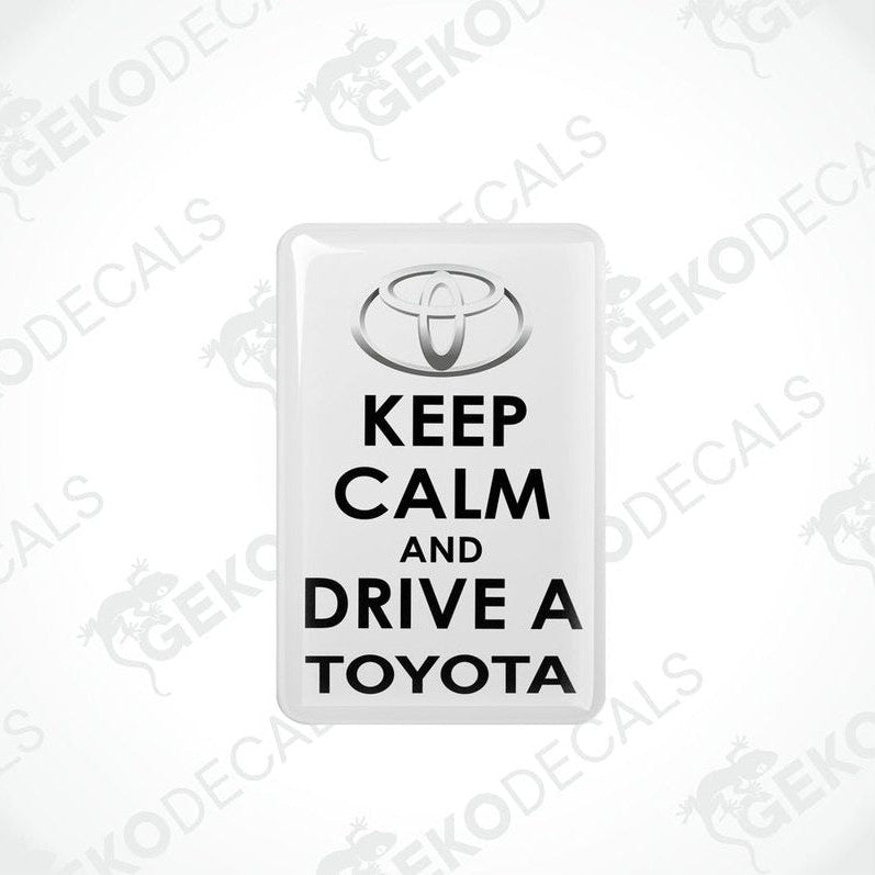 Rectangular withe vehicle decals with black text that read 'KEEP CALM AND DRIVE A TOYOTA', including the Toyota logo.