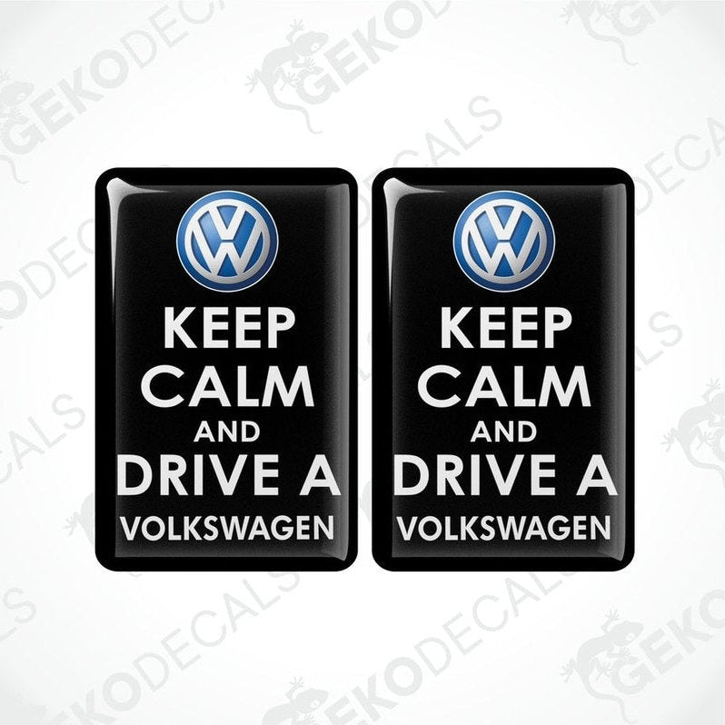 Two black vinyl stickers with the text 'KEEP CALM AND DRIVE A VOLKSWAGEN' and a VOLKSWAGEN logo on them.