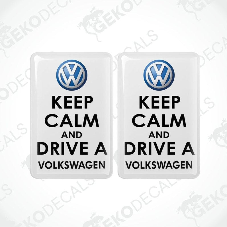Two withe vinyl stickers with the text 'KEEP CALM AND DRIVE A VOLKSWAGEN' and a VOLKSWAGEN logo on them.
