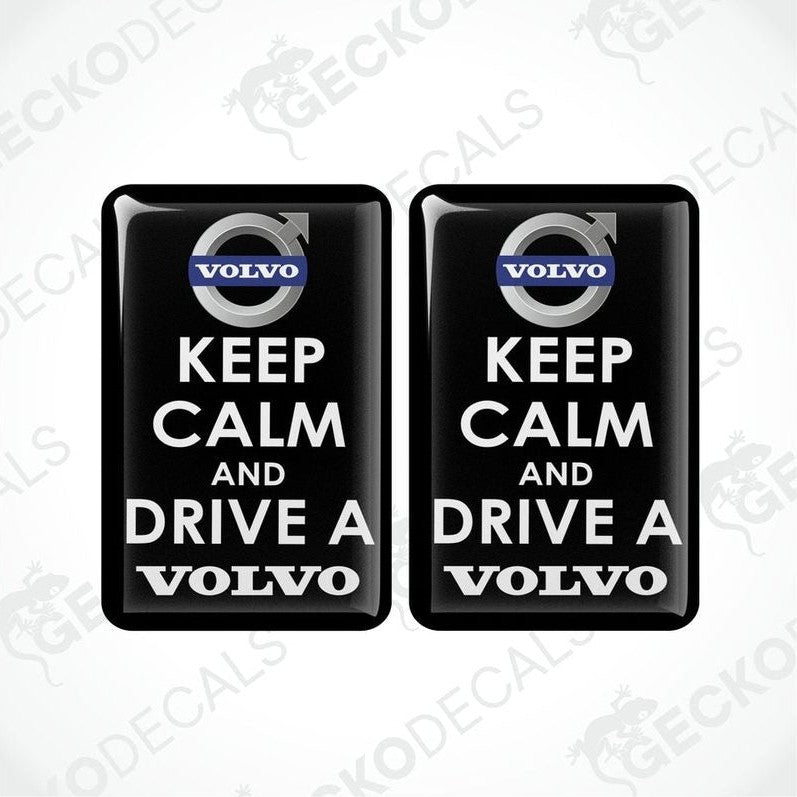 Two rectangular black vinyl decals with white text and the Volvo brand logo, one decal reads 'KEEP CALM AND DRIVE A' and the other reads 'VOLVO'.