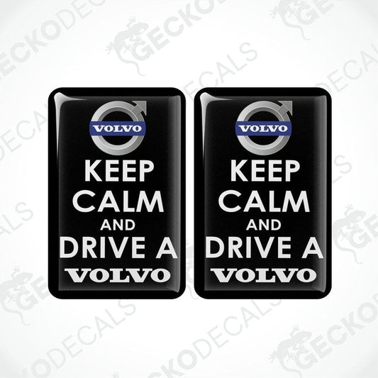 Two rectangular black vinyl decals with white text and the Volvo brand logo, one decal reads 'KEEP CALM AND DRIVE A' and the other reads 'VOLVO'.