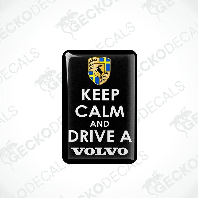 Rectangular black vinyl decals with the text 'KEEP CALM AND DRIVE A VOLVO' in white letters, and the Volvo car logo in yellow and blue.