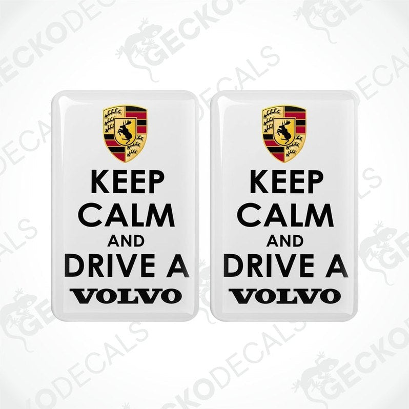 Two withe vinyl stickers with the text 'KEEP CALM AND DRIVE A VOLVO' and a Volvo logo on them.