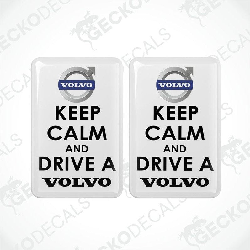 Two rectangular withe vinyl decals with white text and the Volvo brand logo, one decal reads 'KEEP CALM AND DRIVE A' and the other reads 'VOLVO'.