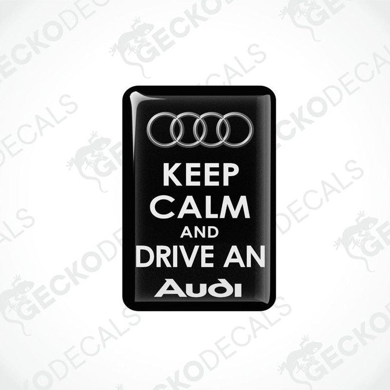 Two black vinyl stickers with the text 'KEEP CALM AND DRIVE AN AUDI' and the Audi logo.