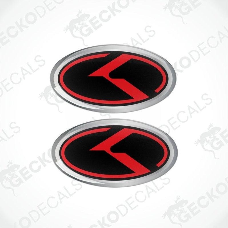 Two oval vinyl stickers with a red and black design and the letter 'KIA' in the center, placed on a white background.