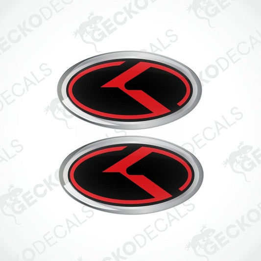 Two oval vinyl stickers with a red and black design and the letter 'KIA' in the center, placed on a white background.