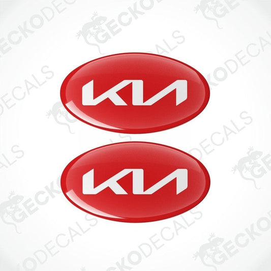 Two red oval-shaped vinyl decals with the KIA logo in white.