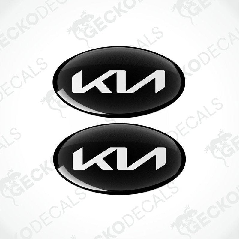 Two black oval-shaped vinyl decals with the KIA logo in white.