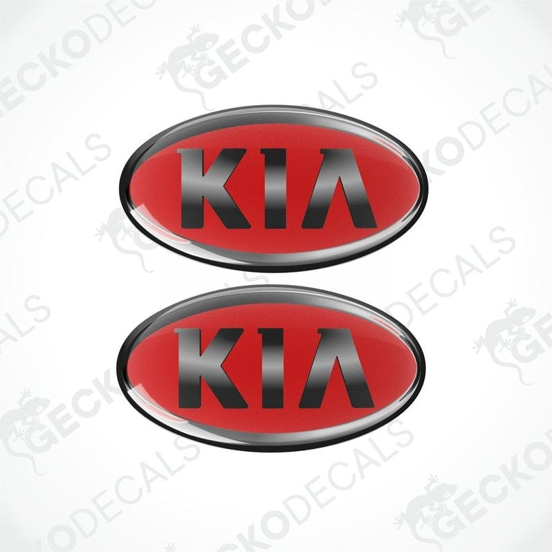 Two red oval-shaped vinyl decals with the KIA brand logo in dark grey text.