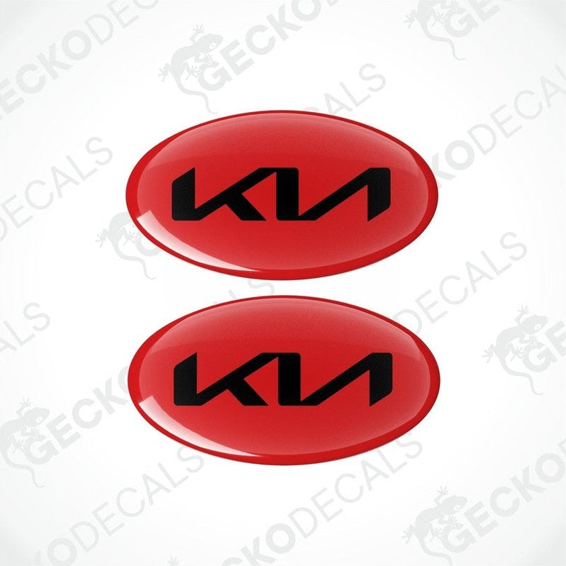 Two red oval-shaped vinyl decals with the KIA logo in black.