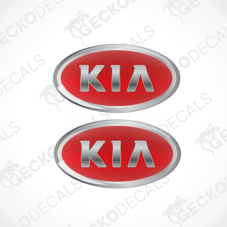 Two red oval-shaped vinyl decals with the KIA brand logo in silver text.