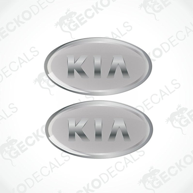 Two grey oval-shaped vinyl decals with the KIA brand logo in silver text.