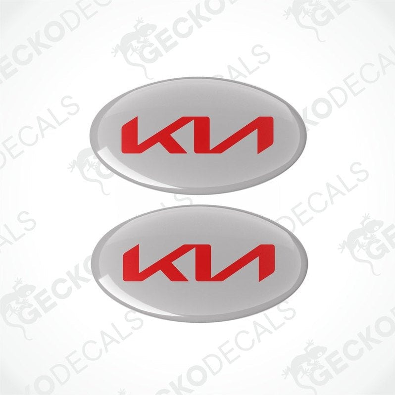 Two oval vinyl stickers grey a red 'KIA' logo in the center, placed against a white background with the text 'geckodecals'.