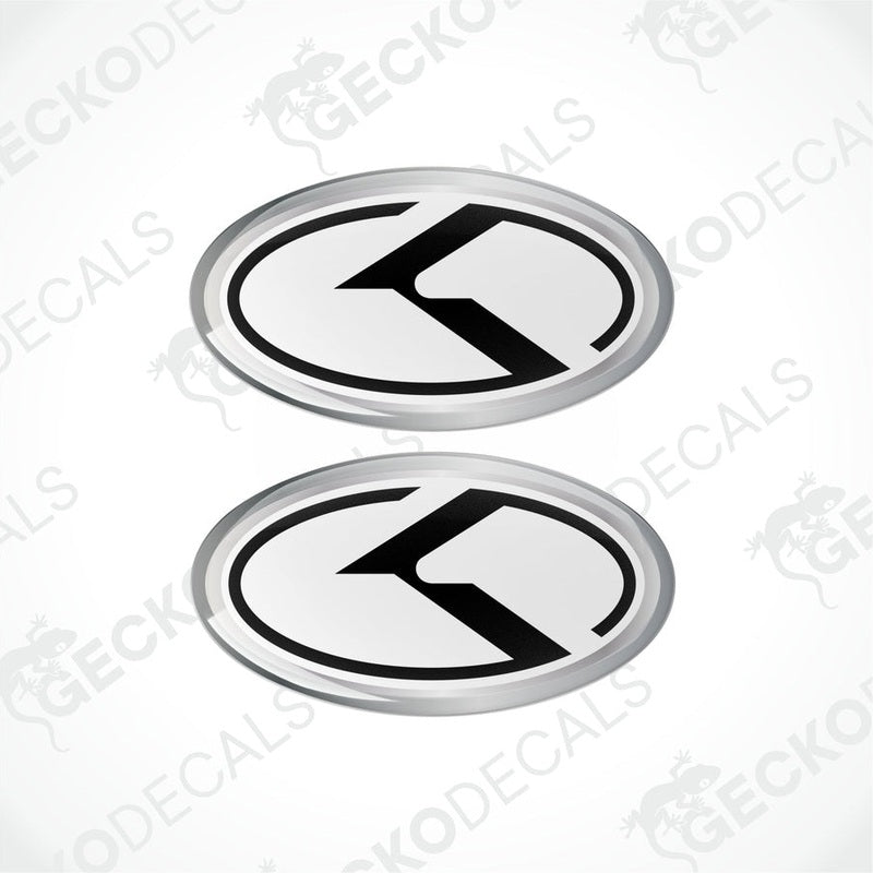 Two oval vinyl stickers with a white and black design and the letter 'KIA' in the center, placed on a white background.