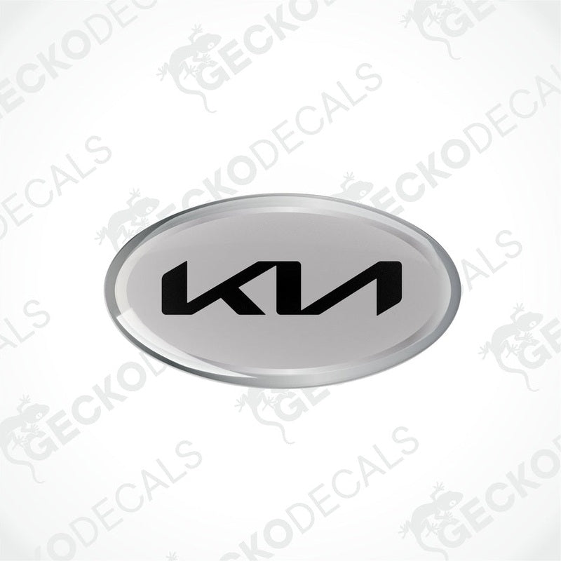 Oval-shaped vinyl decals with 'KIA' written in bold letters, predominantly grey with black and silver accents.