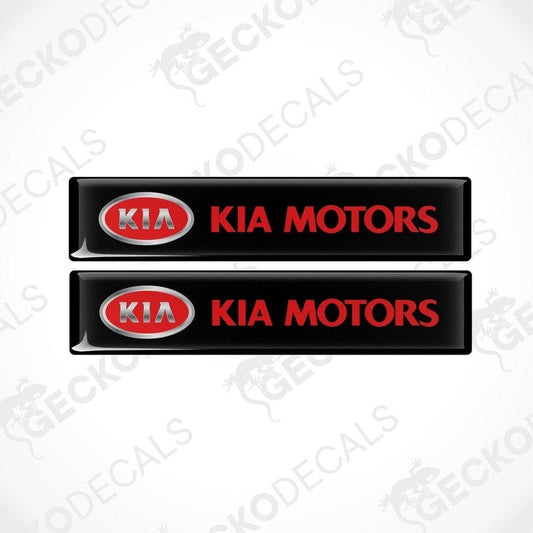 Two black vinyl stickers with the Kia Motors logo in red and white.